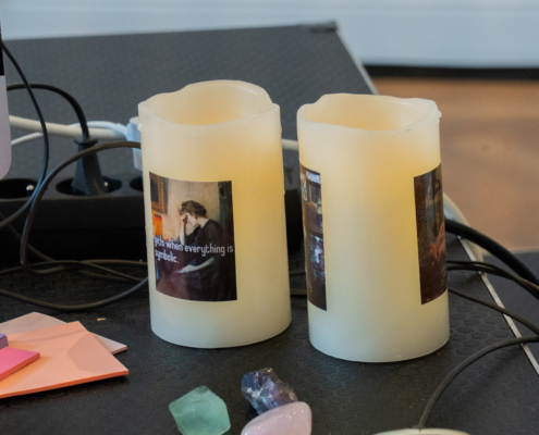 Zwei Kerzen mit individuellen Fotodrucken auf einem Schreibtisch
